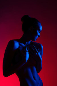 Andrey Guryanov - Young woman in casual clothes standing under neon light
