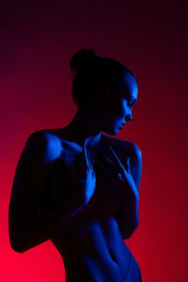 Andrey Guryanov - Young woman in casual clothes standing under neon light